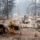 A firefighter extinguishes a hot spot in a neighbourhood destroyed by the Camp Fire in Paradise, California, U.S., November 13, 2018. REUTERS/Terray Sylvester - RC17432D5820